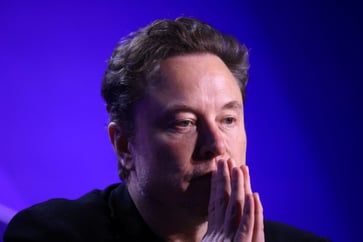 Tesla's stock price drops 6% following news of a delayed robotaxi unveiling.