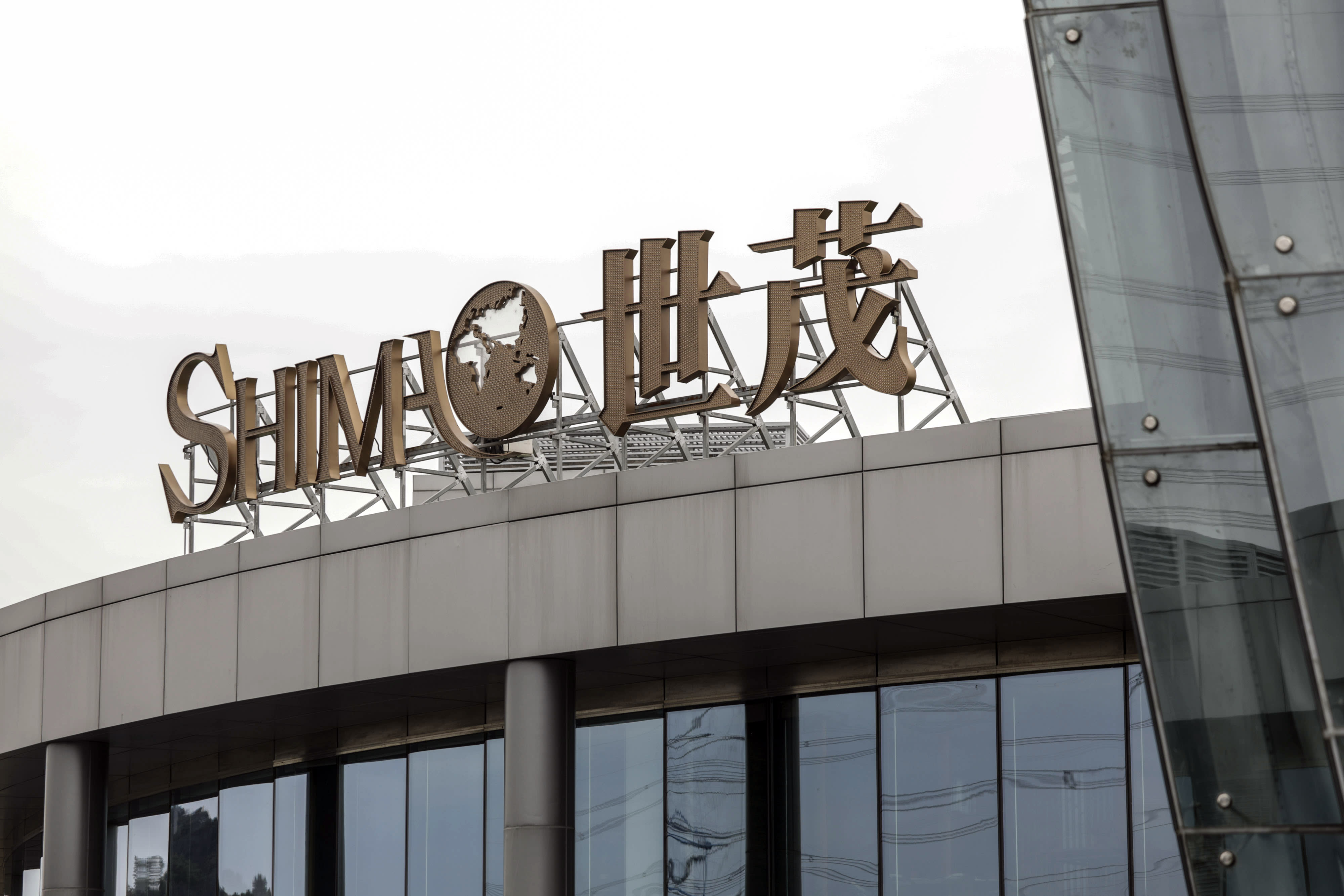Chinese property developer Shimao faces debt troubles, leading Moody's to downgrade its credit rating.