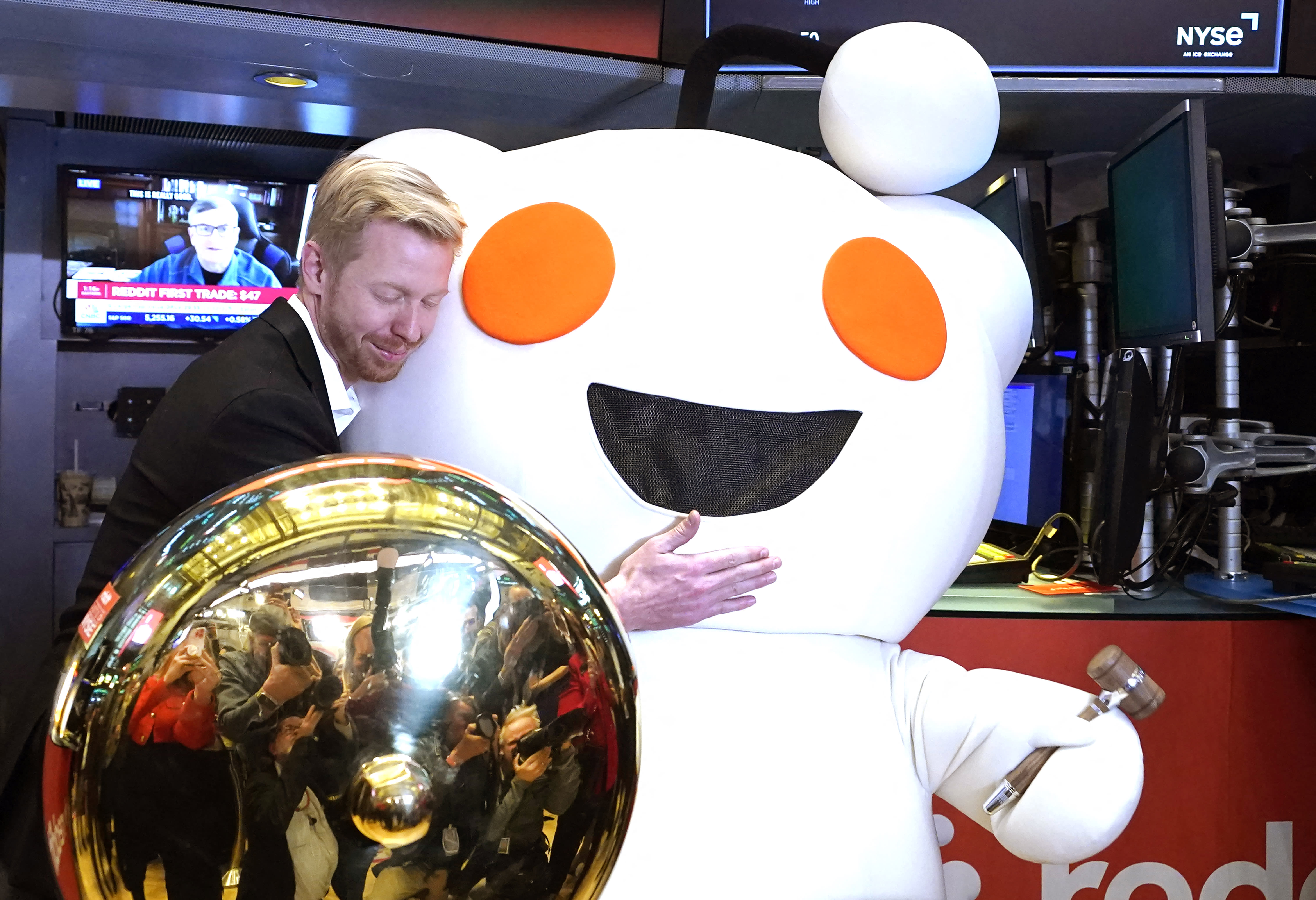 Following its IPO, Reddit's stock price experiences a 30% increase in value, with shares closing up.