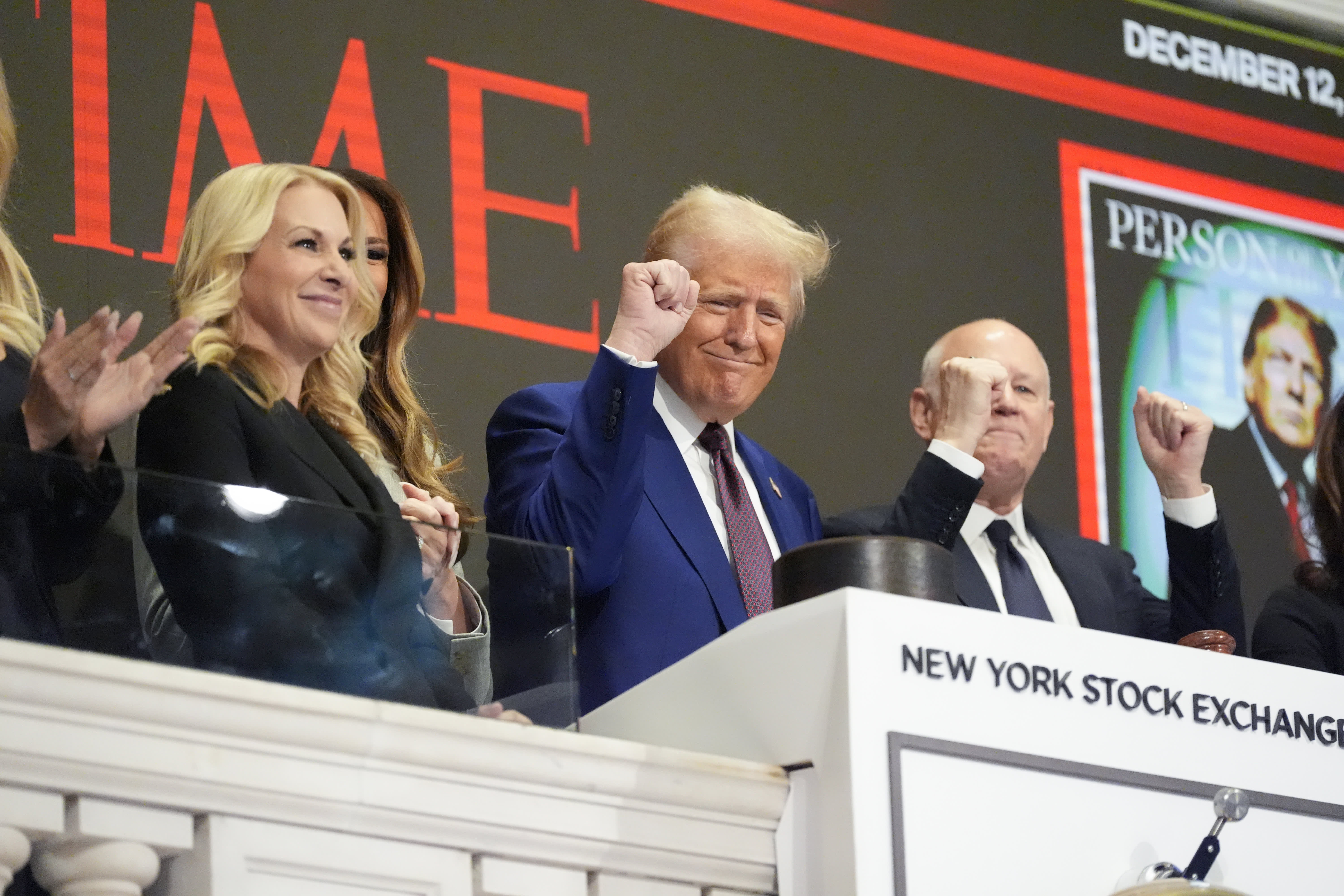 At the New York Stock Exchange, Trump sounds the bell to applause of "USA" as Wall Street executives and business leaders observe.