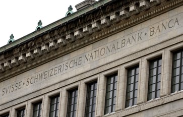 The Swiss central bank reduces interest rates by a quarter point for the third time this year.