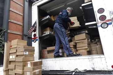 The U.S. Postal Service proceeds with its plan to invest heavily in gasoline-powered vehicles, despite criticism.