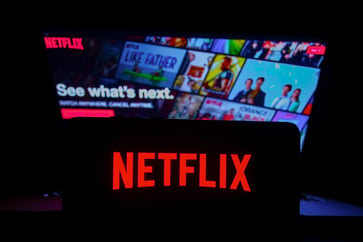 Netflix's stock price rises as the company announces increasing revenue and over 300 million subscribers.