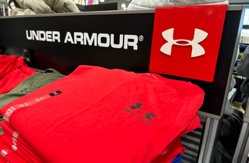 Retailer's decision to reduce discounts and promotions leads to decline in Under Armour sales.