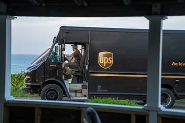UPS reports 12,000 job cuts due to decreased package volume in the last quarter.