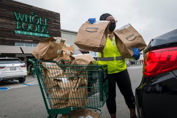 Whole Foods may soon introduce robot warehouses for customers to pick up other orders during checkout, as Amazon tests the idea.