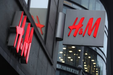 H&M's profit miss and abandoned earnings margin target cause shares to drop by up to 8%.