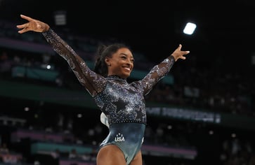 Simone Biles defends her job at the Olympics, saying "I love my black job" after winning a gold medal.