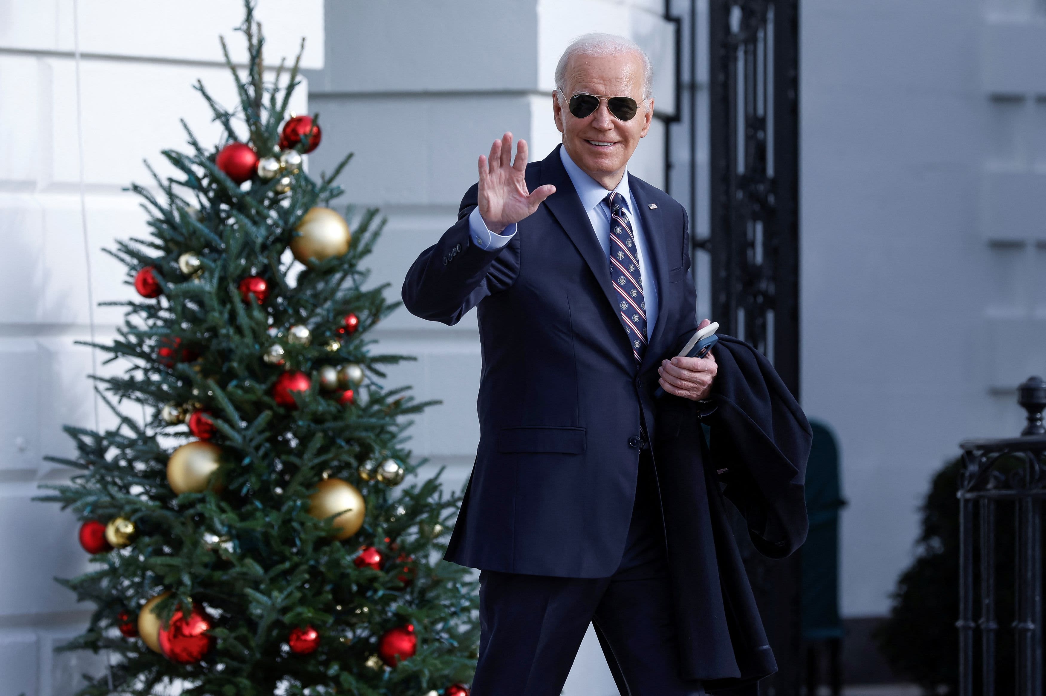 Despite a decline in approval for President Biden, holiday spending is expected to increase, according to a CNBC economic survey.