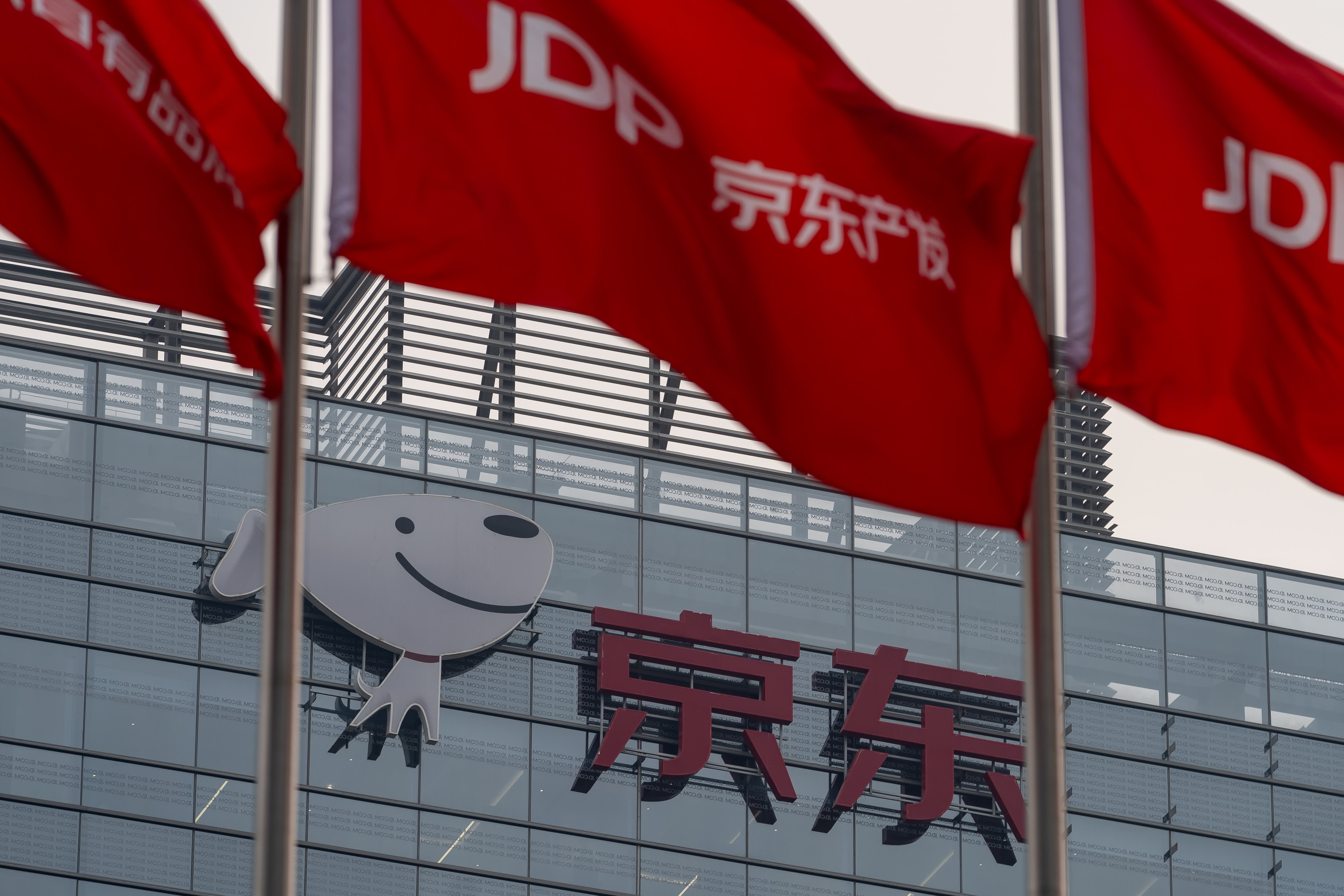 JD.com's stock price rises after announcing a $5 billion share buyback, despite a decline in the Hang Seng index.