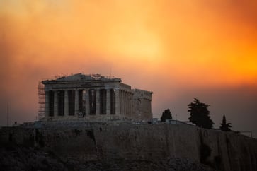 Residents near Athens are fleeing their homes as a massive wildfire rages in Greece, as shown in photos.