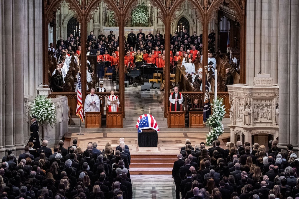 Images depict the solemn procession of Jimmy Carter's funeral.