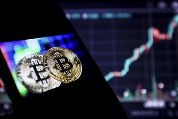 Bitcoin retreats from new record, but cryptocurrencies bounce back.