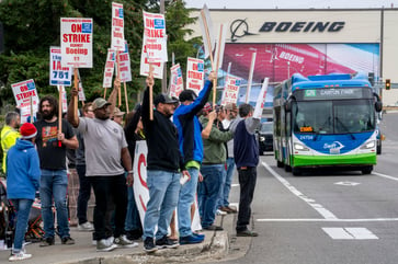 Boeing pauses hiring amidst factory worker strike and cost-cutting measures.