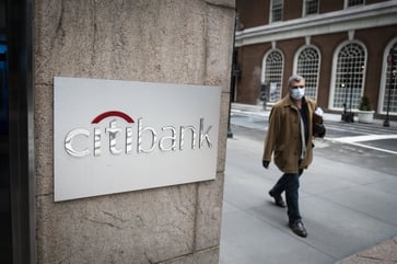 Citigroup's shares drop after a 26% decline in fourth-quarter profits.