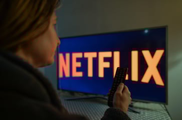 Netflix's stock experiences a 16% increase following Wall Street's endorsement of ad-driven subscriber growth.