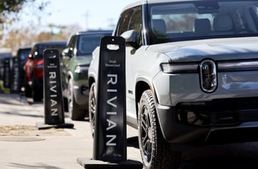 Rivian exceeds 2024 vehicle production target despite reducing expectations.