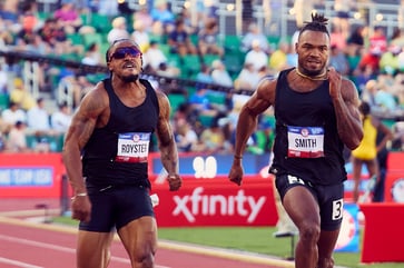 Numerous Olympic aspirants are competing in all-black, unmarked athletic attire.