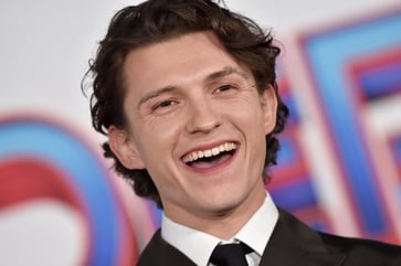 Director praises Tom Holland's charisma, confidence, and energy for landing the Spider-Man role at age 19.