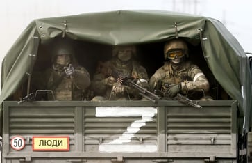 Russia's invasion of Ukraine is depicted in photographs.