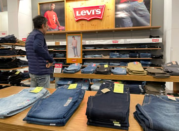 Levi Strauss is considering selling its Dockers business and has reduced its guidance accordingly.