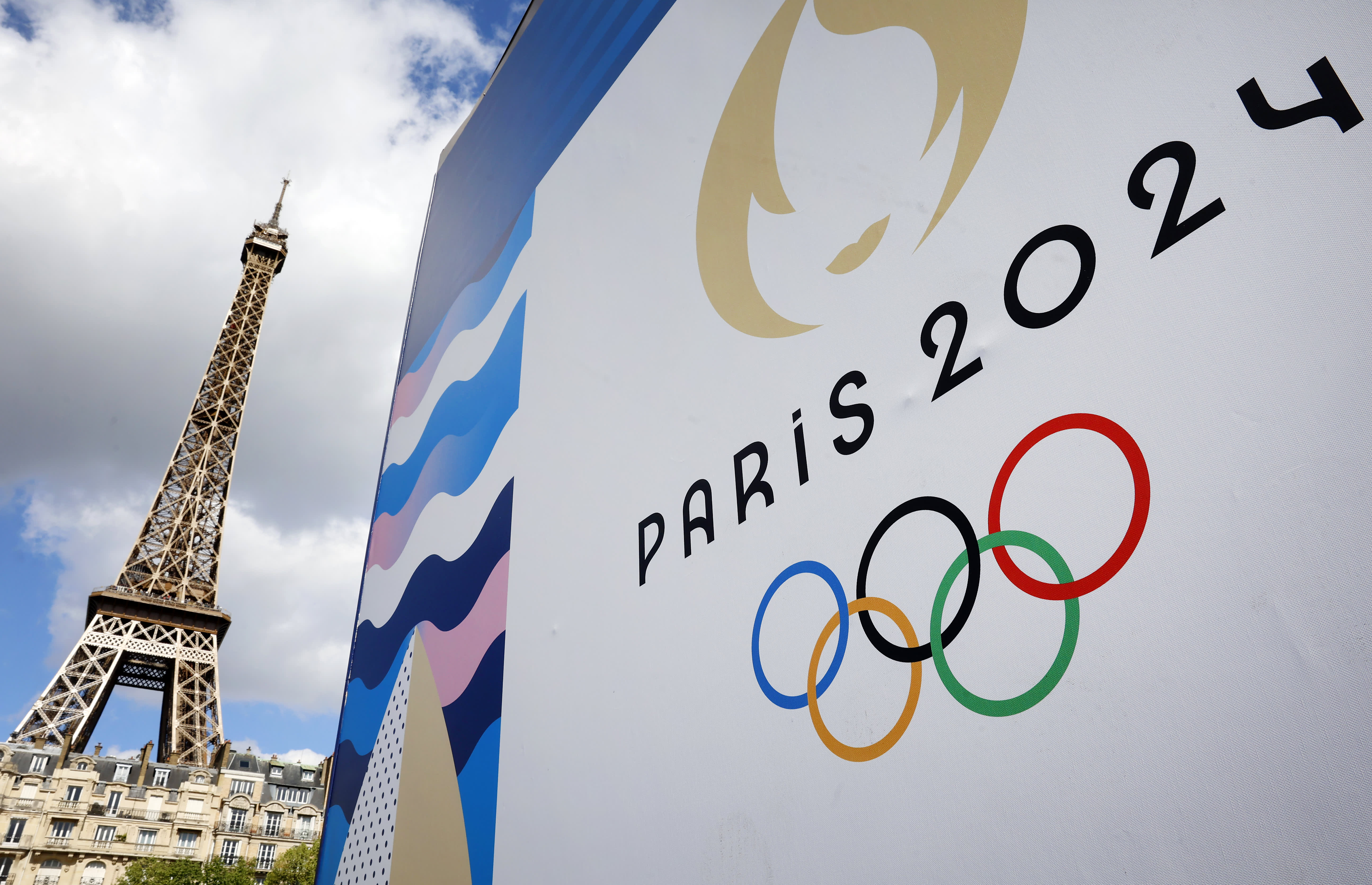 What factors contributed to the lower cost of the Paris Olympics compared to previous host cities such as Rio, London, and Tokyo?
