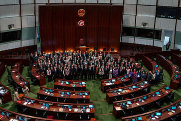 The national security law in Hong Kong is causing disagreement among analysts regarding its social and economic effects.