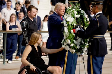 An Arlington cemetery employee was pushed by a Trump aide while attempting to enforce rules, according to the Army.