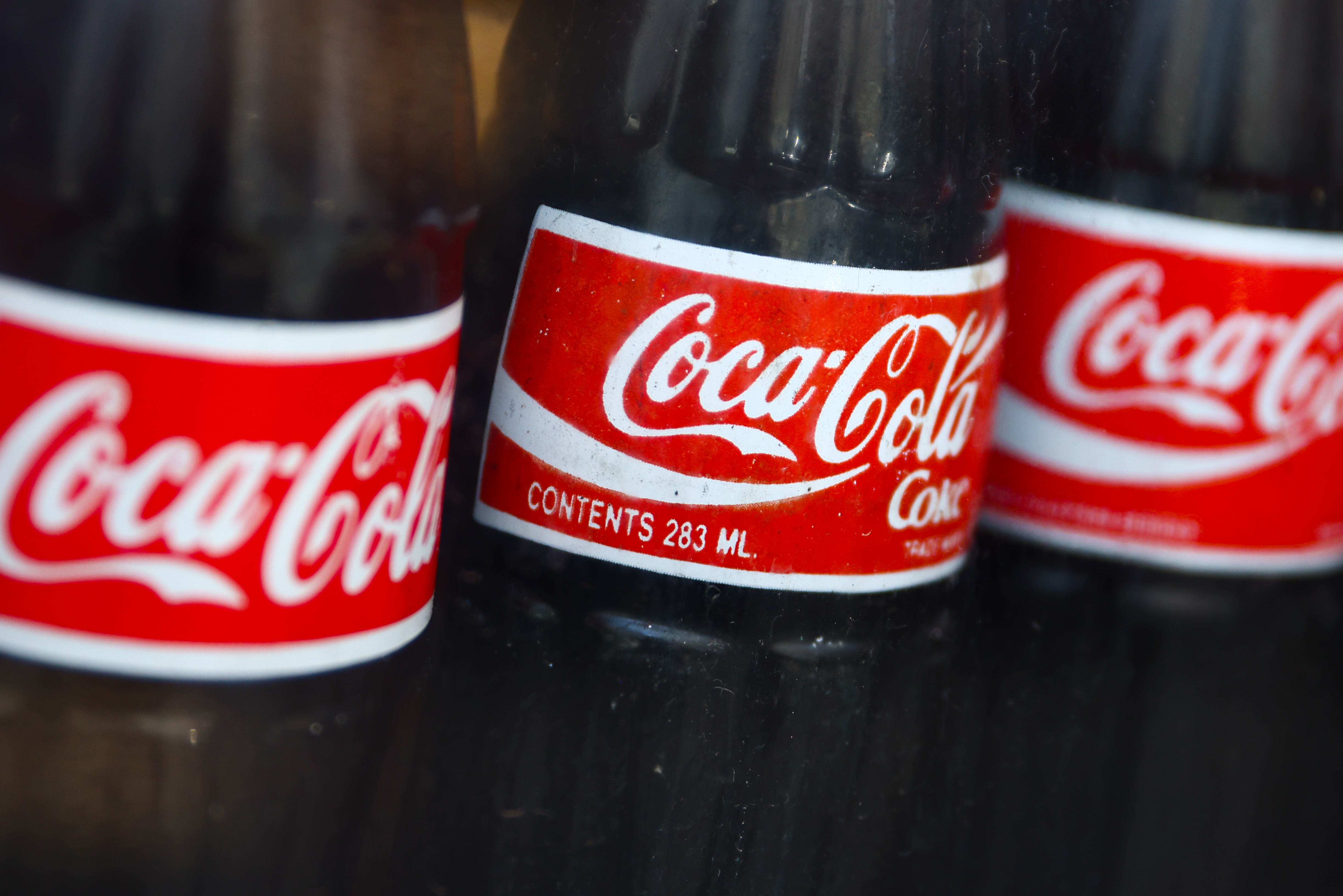 Higher prices help Coca-Cola beat earnings estimates, despite sluggish demand.