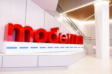 Moderna's stock price drops by 18% following a $1 billion reduction in its 2025 sales forecast.