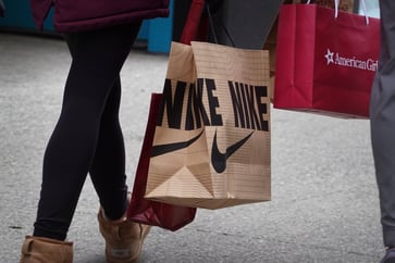 Nike and Foot Locker's stocks decline after the athletic apparel company lowers its revenue forecast.